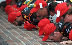 Ty Dillon and team kiss the bricks at Indianapolis Motor Speedway (photo - Rainier Ehrhardt/Getty Images